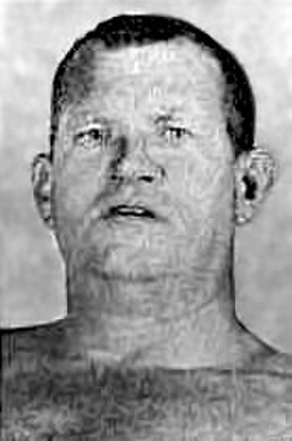 Head and shoulders photograph of Fritz Von Erich, a broad faced man with short hair, from a 1973 wrestling program
