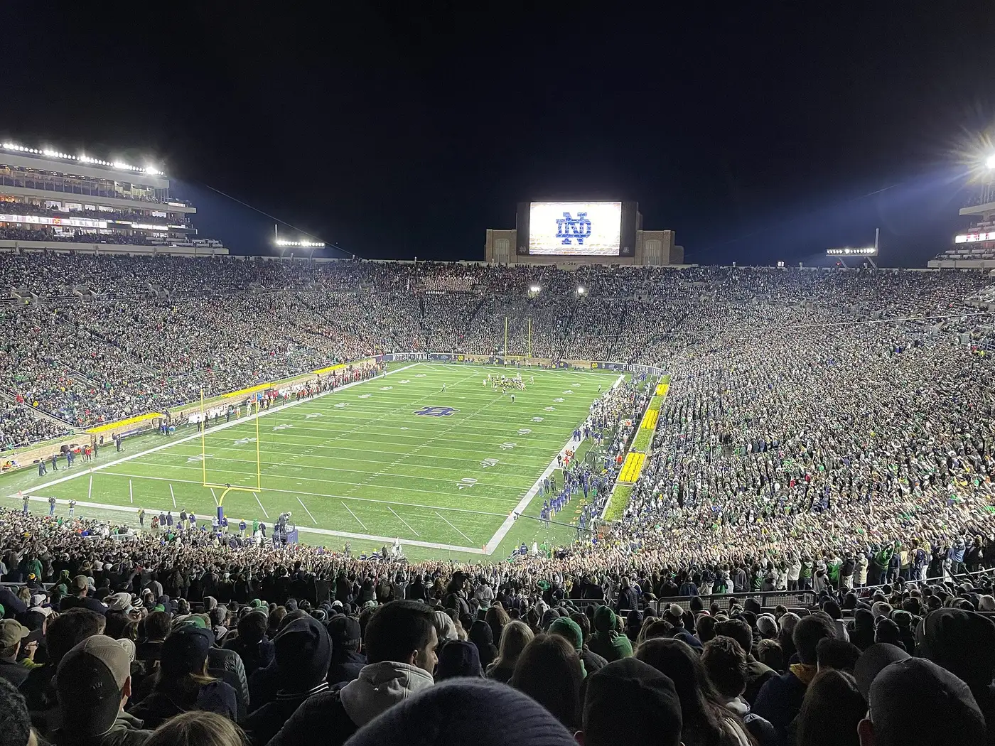 Notre Dame Stadium full of fans under the lights at night