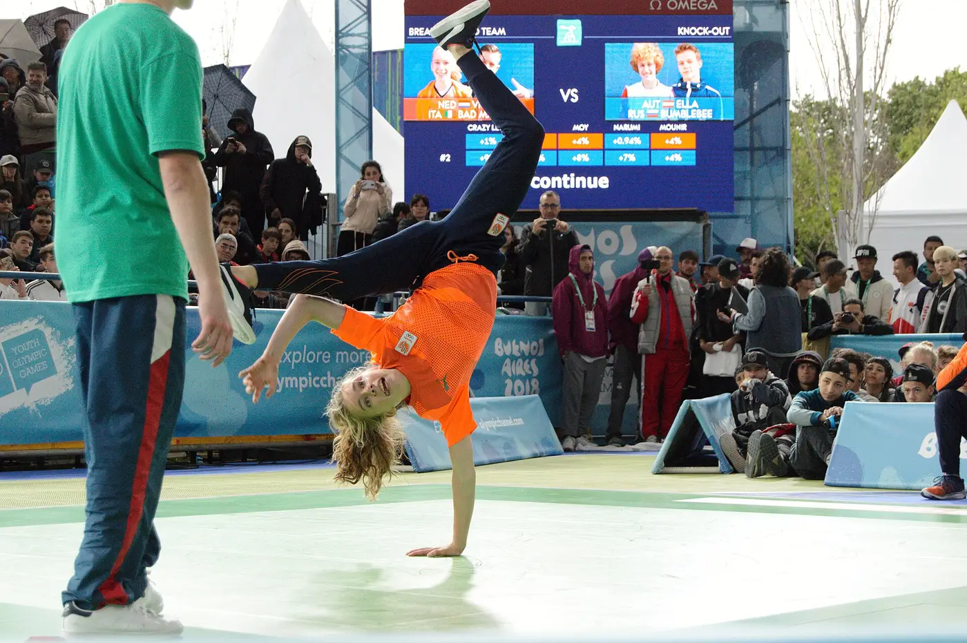 A breaker balancing on one hand during a battle at the 2018 Youth Olympic Games