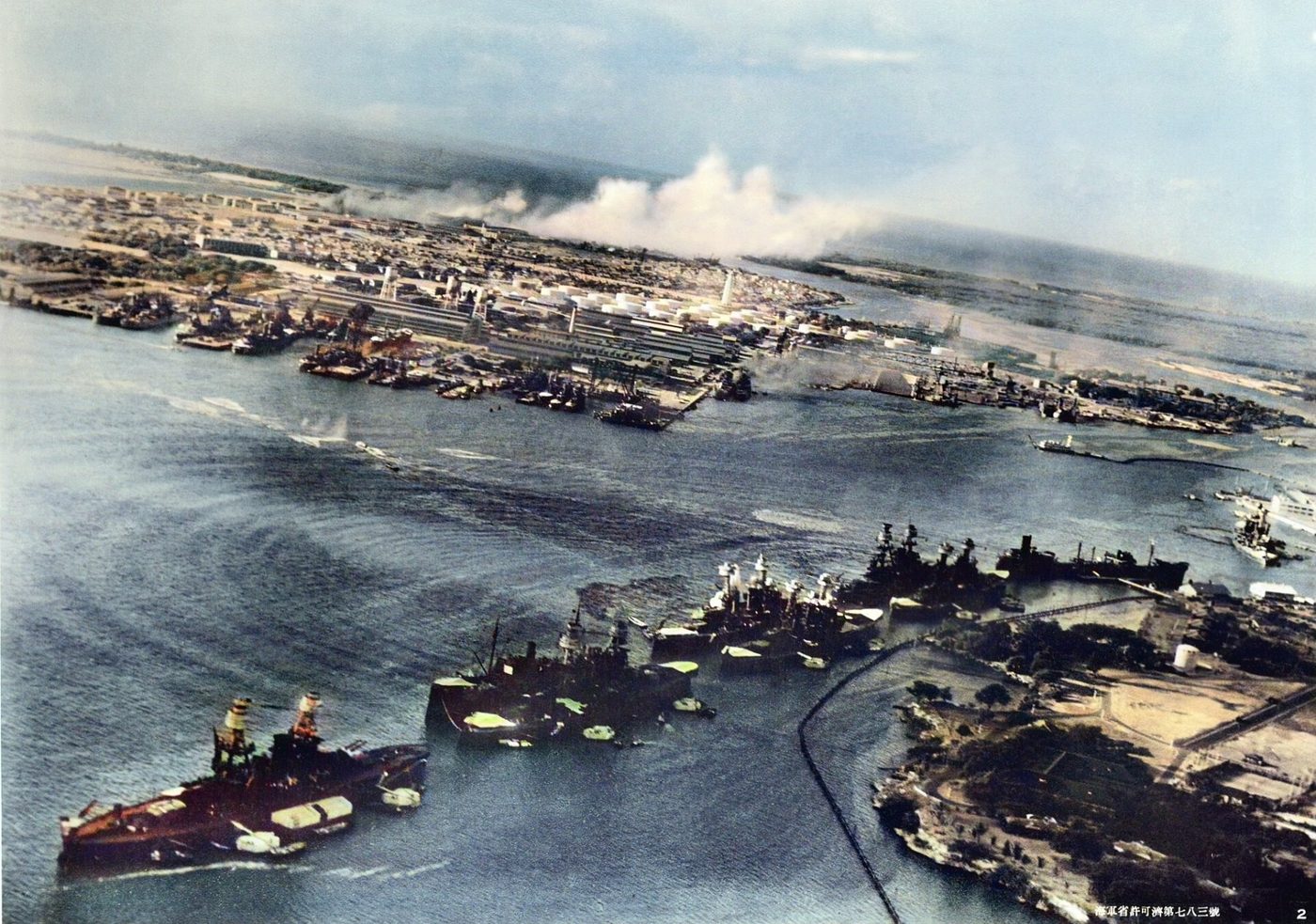 Aerial view of Battleship Row beside Ford Island with torpedo wakes and spreading smoke, photographed from a Japanese plane.