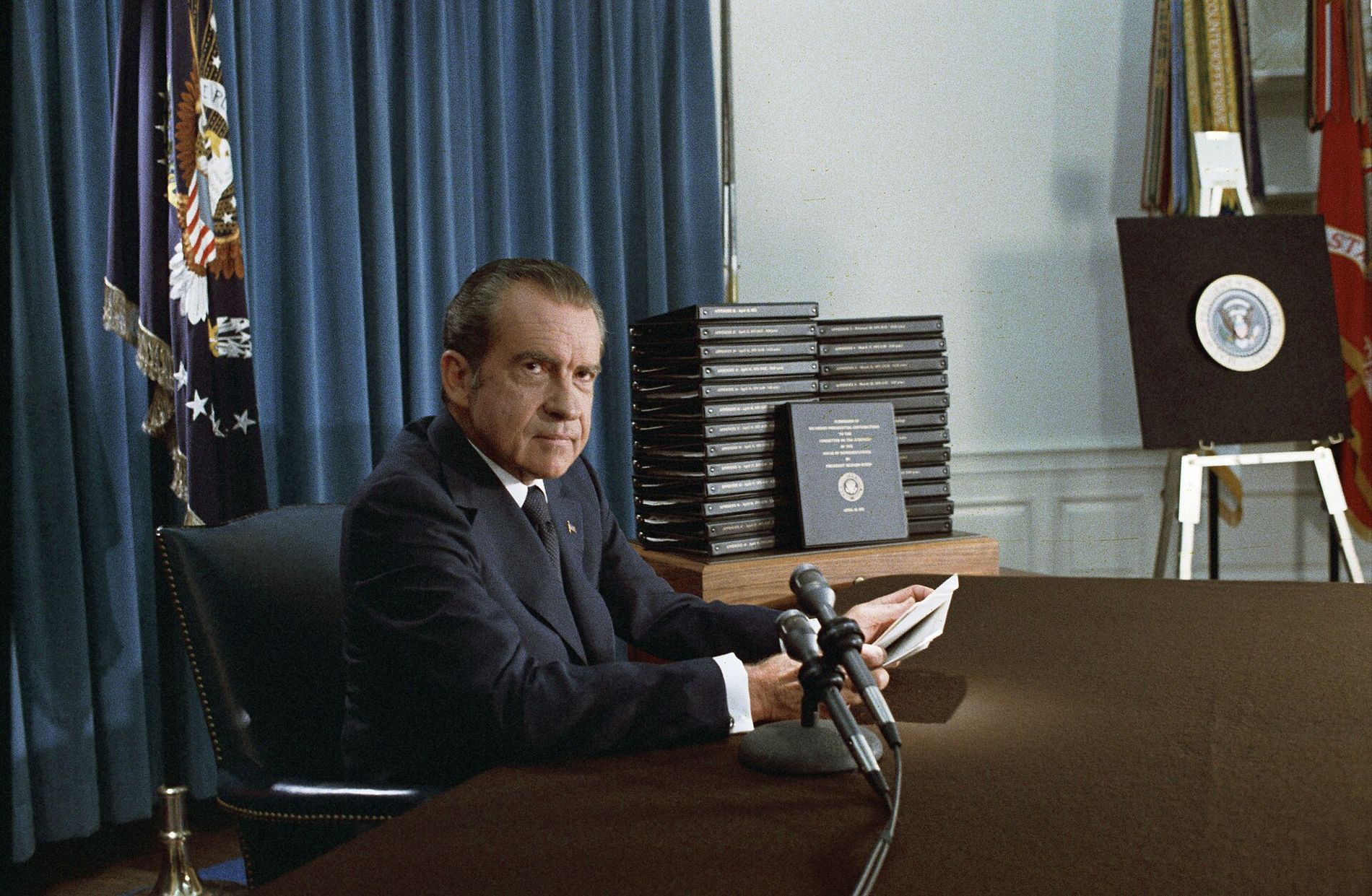 President Nixon beside a stack of edited White House tape transcripts, April 29, 1974