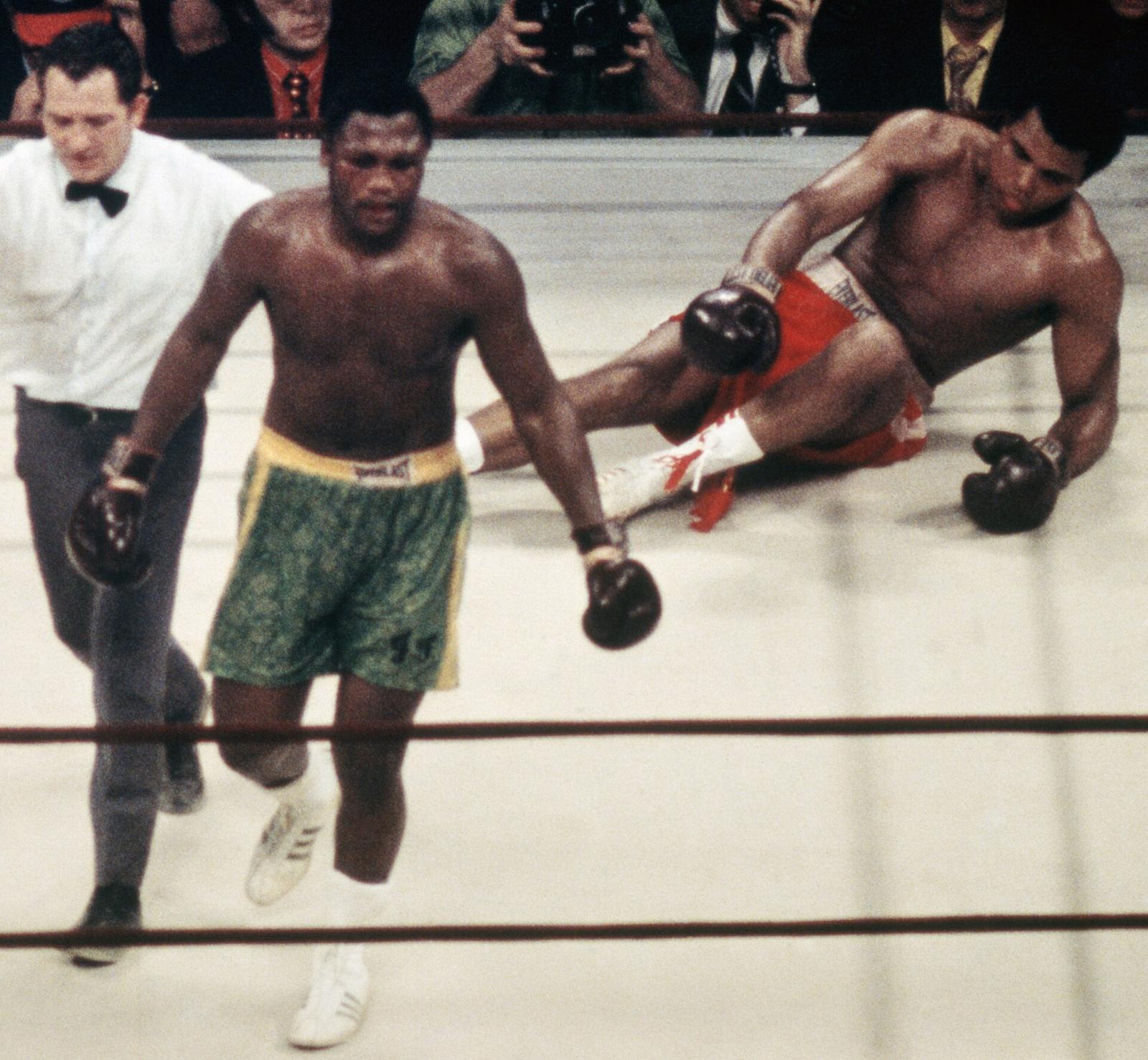 Joe Frazier walking to a neutral corner as Muhammad Ali lies on the canvas, March 8, 1971