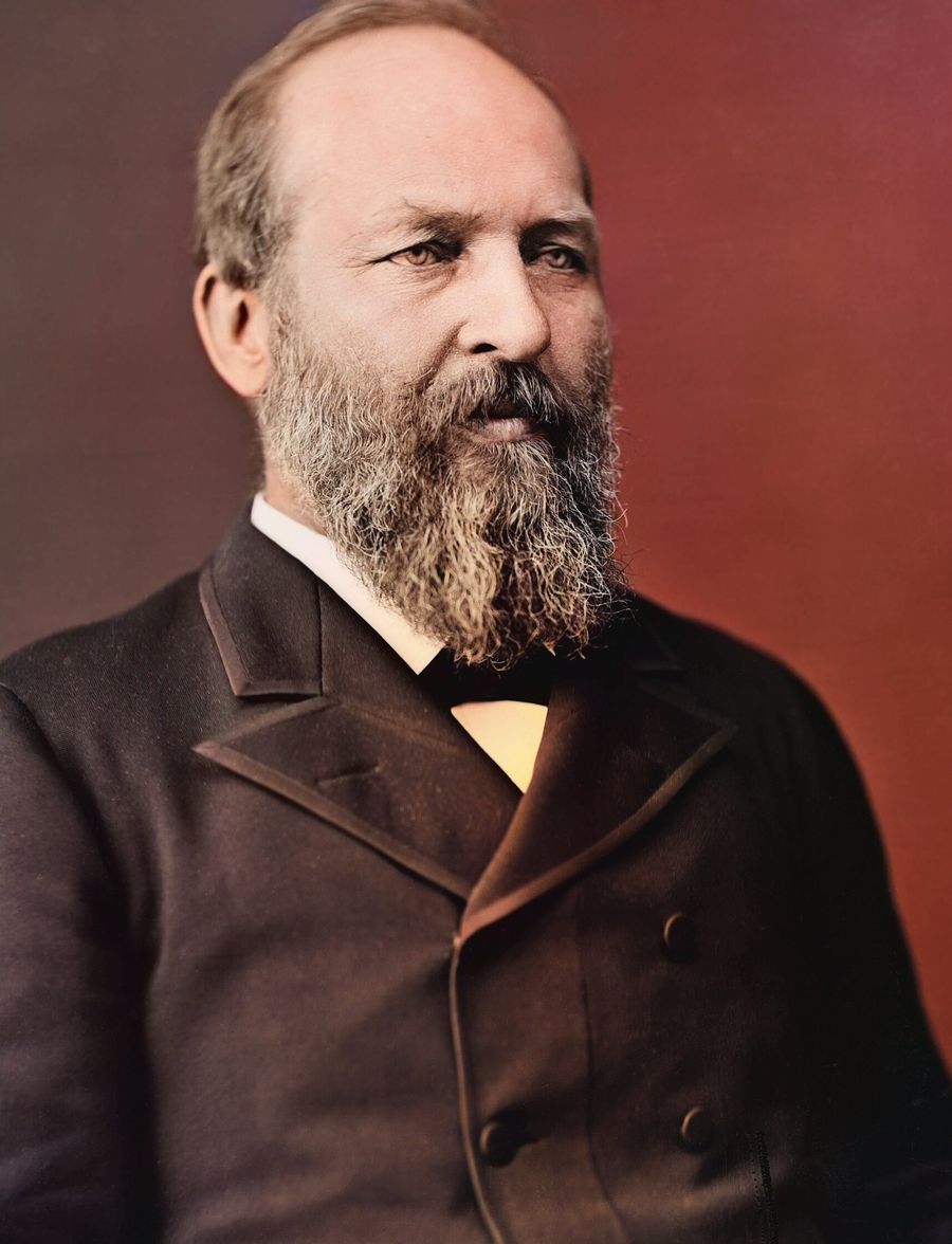 Colorized portrait of James A. Garfield with a full brown beard, receding hair and a dark coat