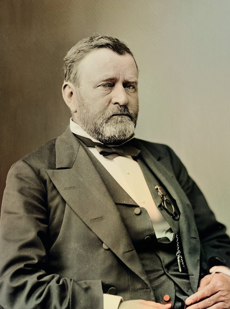 Colorized portrait of Ulysses S. Grant, seated, with a short graying beard and a dark suit