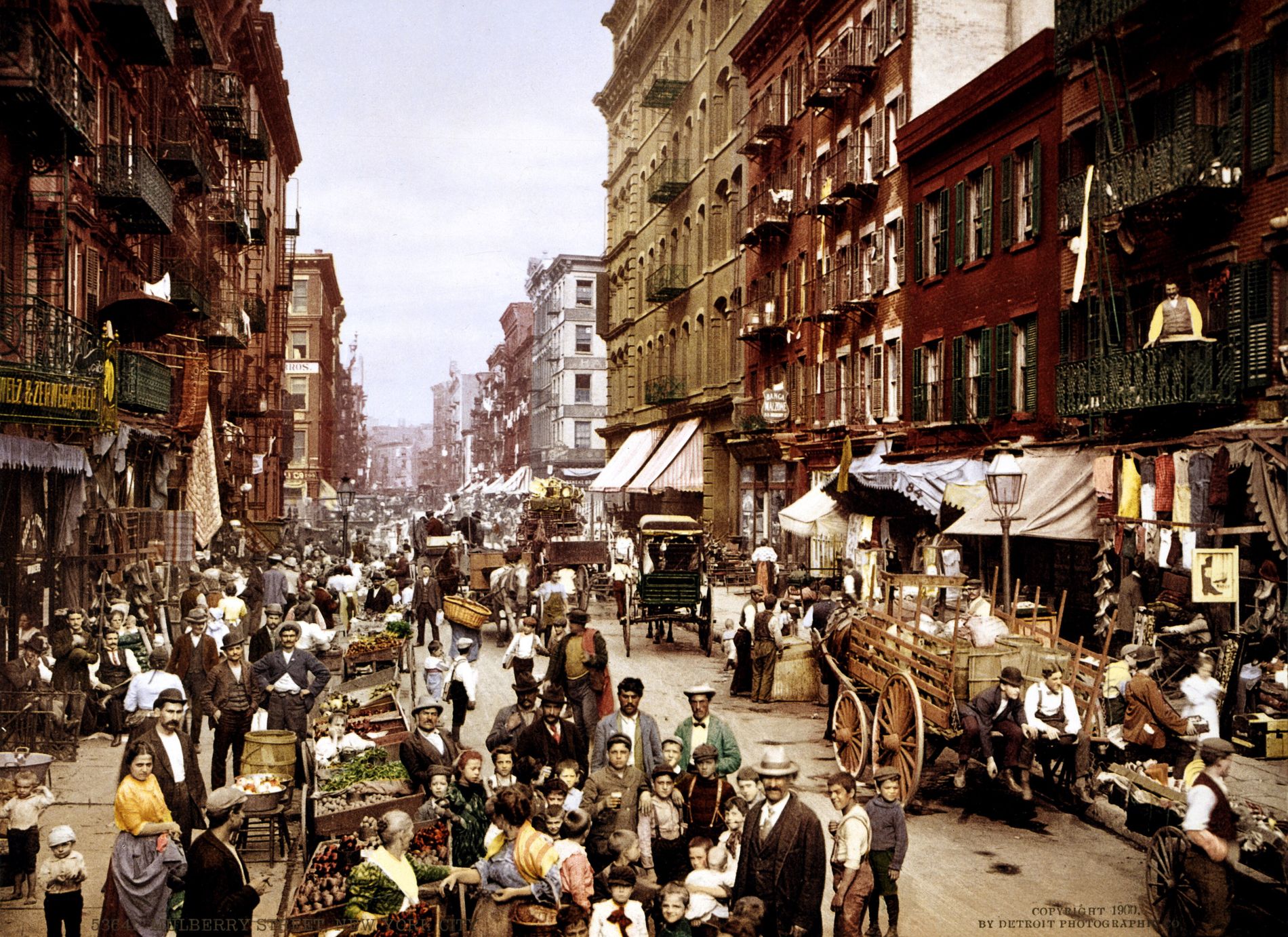 Early color photograph of a crowded Mulberry Street in New York around 1900