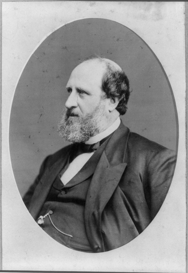 Portrait of William M. Tweed, a heavy man with a beard, in a dark suit.