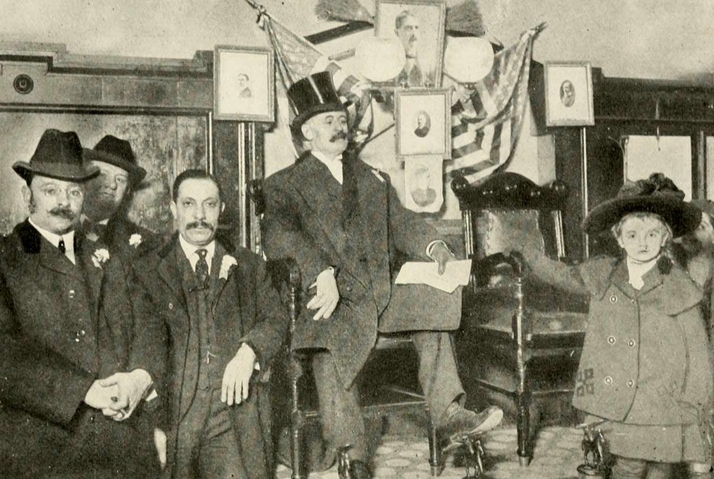 George Washington Plunkitt in a top hat seated on a raised shoeshine chair, with men in overcoats and a small girl beside him.