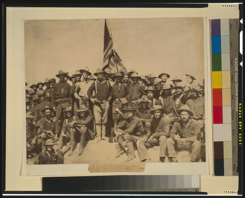A group of soldiers posed on a captured hill after fighting in Cuba.