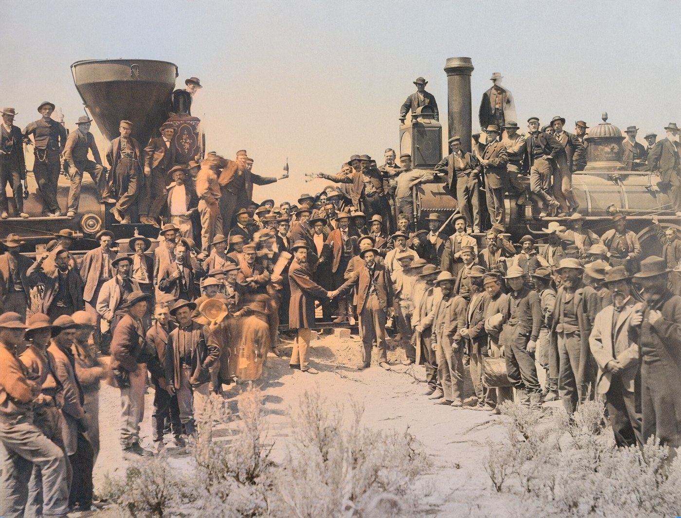 Colorized photograph of crowds and two locomotives meeting at Promontory Summit, 1869