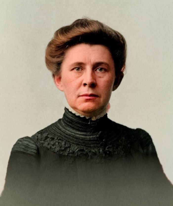 Portrait of Ida Tarbell, a woman with her hair pinned up, in a dark high collared dress.
