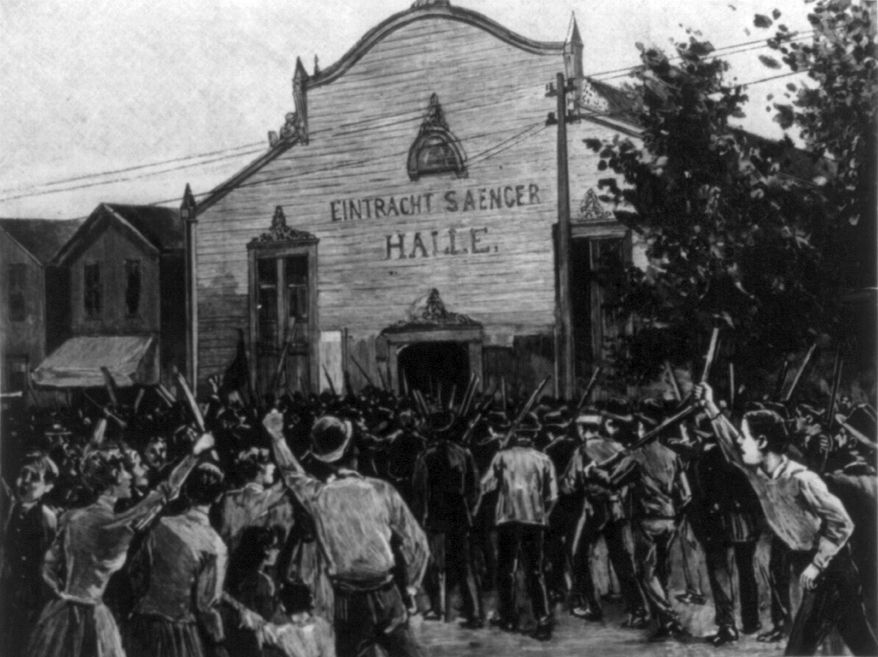 Engraving of a crowd of men in front of a hall, some with raised fists and clubs, surrounding a line of Pinkerton guards.